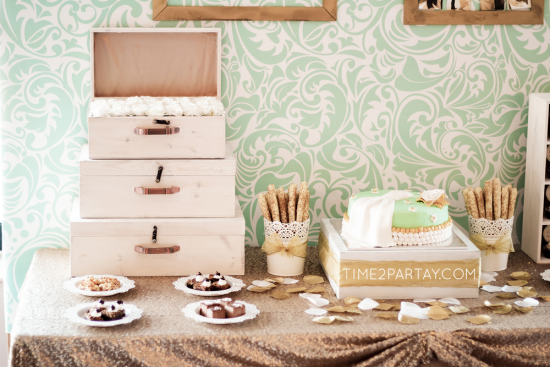 A Mint to Be Bridal Shower dessert table with luggage and flowers